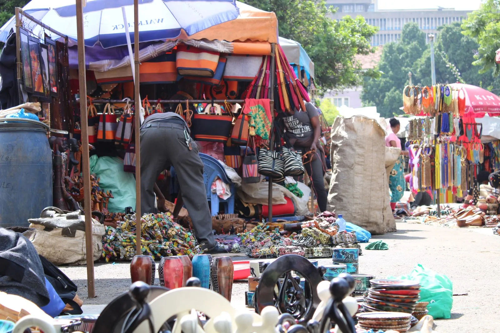 Stalls of bags, carvings, beadwork and shoes at an open-air craft market in Nairobi
