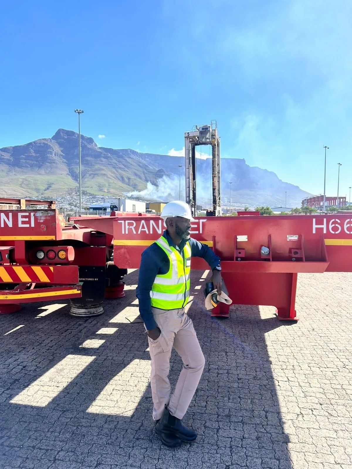 Container handling equipment at the Cape Town port yard with Table Mountain behind