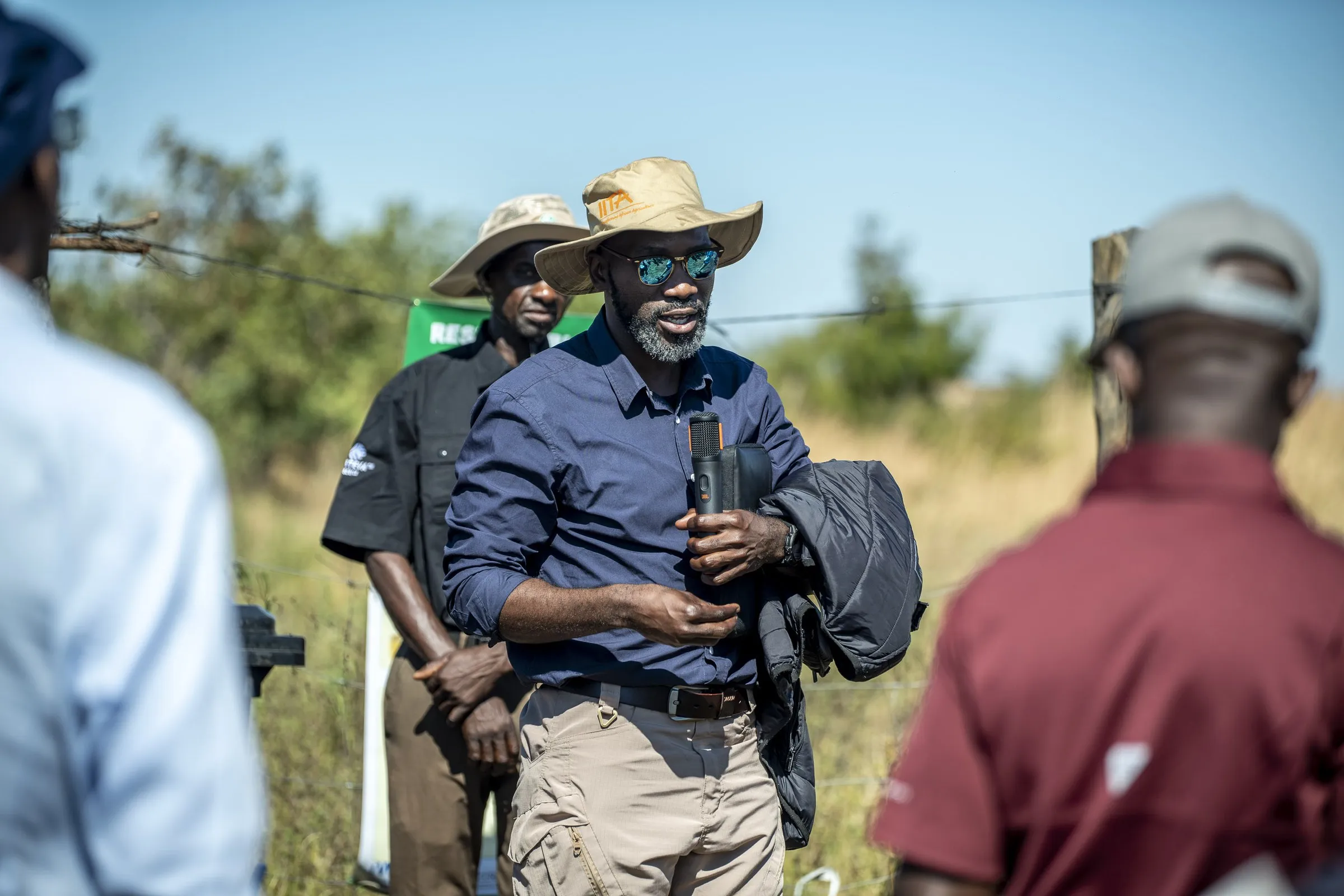 Evans Chinembiri talking with farmers during a field visit